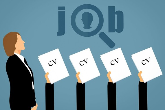 Woman is suit and hands holding a CV