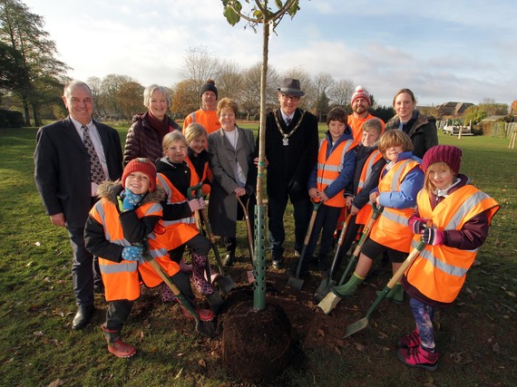 The Mayor with a group of children planting a tree