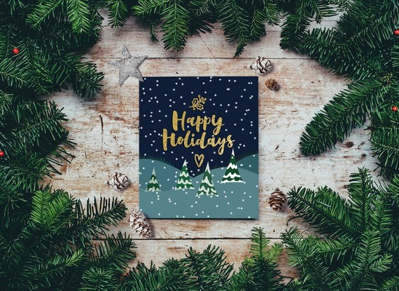 Happy Holidays on a card surrounded by garlands