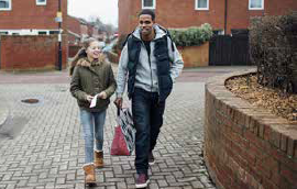Man and girl walking down street
