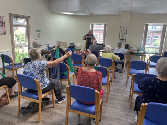tenants at yew tree court doing fitness with graham. using chairs