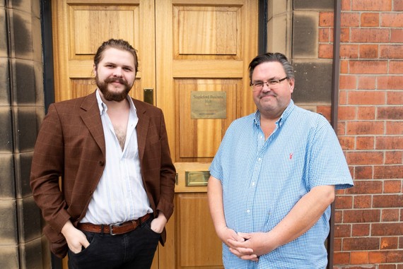 Two owners stood in front of officces