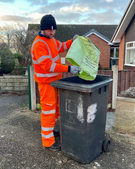 Refuse man collecting glass