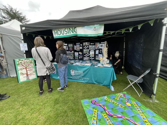 Customers looking at our information stall under a gazebo at a playday