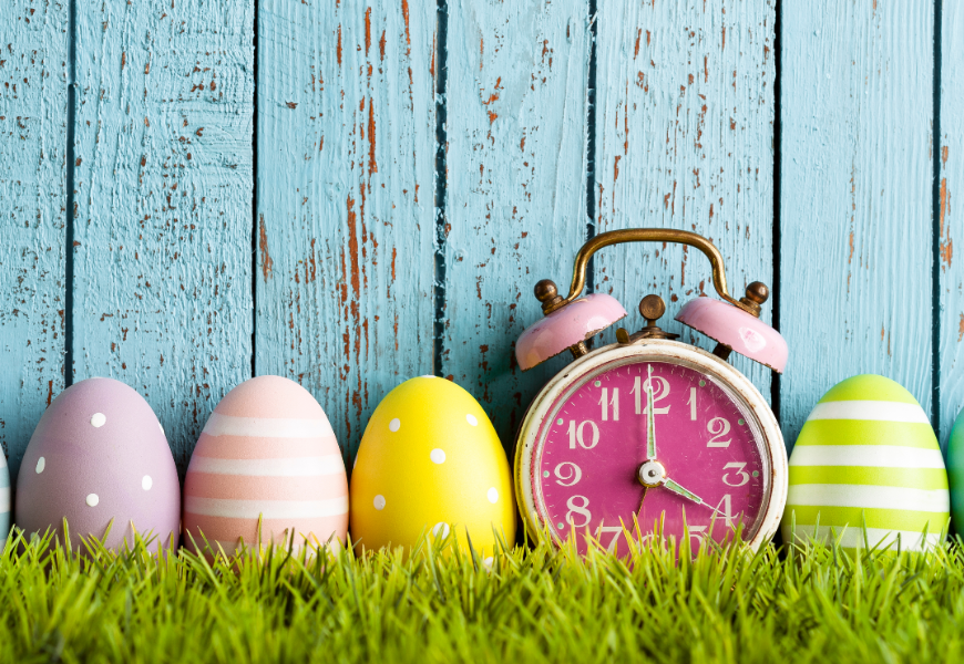 Easter eggs next to clock