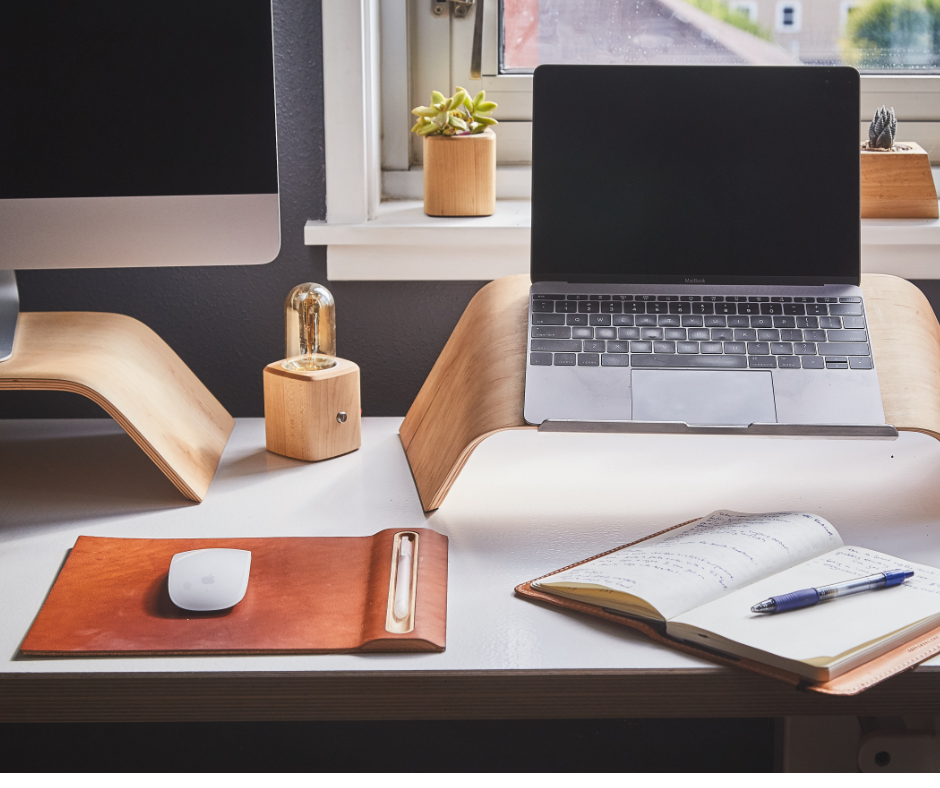 Laptop and notebook on desk