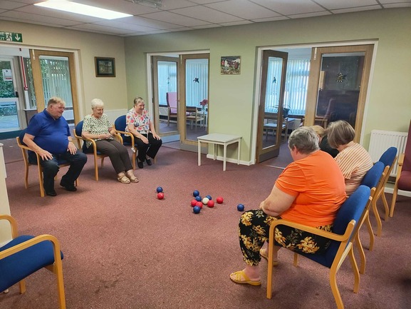 Residents sitting throwing balls