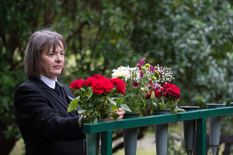 A woman placing flowers