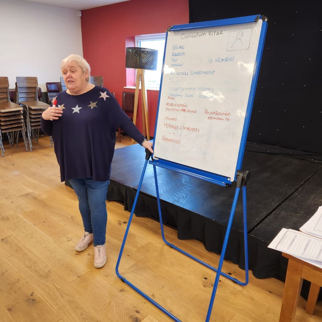 Teresa delivering training in front of a white board