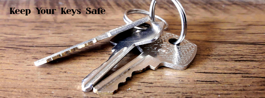 three silver keys on a brown table. With texts say keep your keys safe