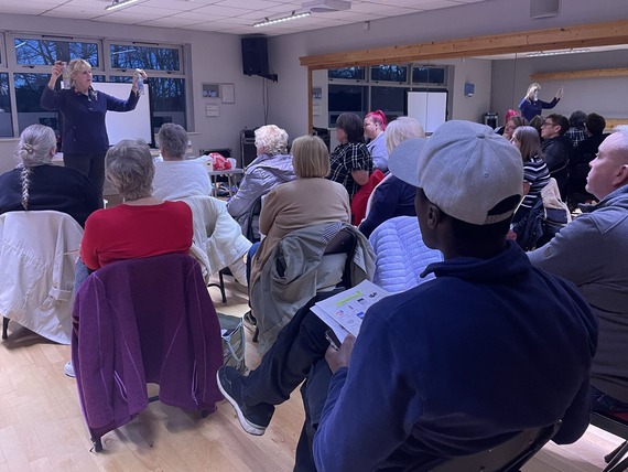 room full of people listening to a presentation on recycling
