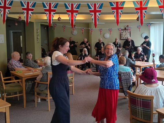 People dancing under bunting