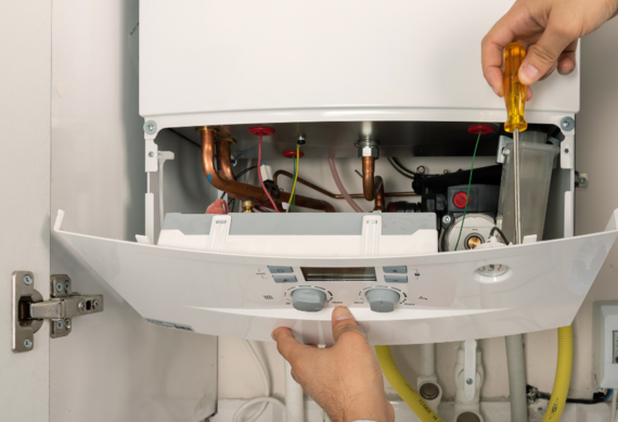 boiler open and person fixing it