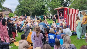 Crowd gathered round to watch a pinxton puppet show