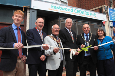 People smiling opening a shop