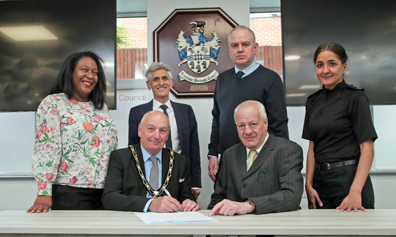 Councillors, MPs and the Police signing the pledge in the Council Chamber
