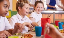 Primary school pupils having lunch