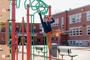 Young child playing on a climbing frame.