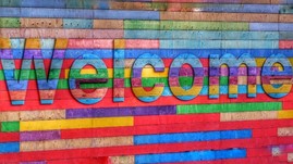 Rainbow wall with the word Welcome