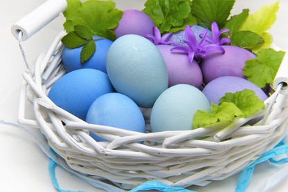 White basket of coloured eggs