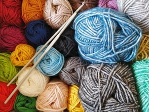 Multi coloured knitting wool and needles