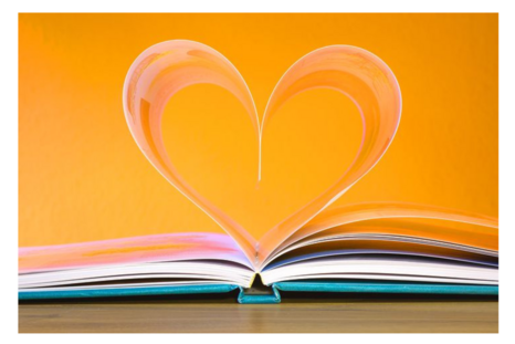 An open book with pages folded to make a heart shape.