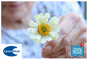 Closeup of hand holding a white flower, carers week logo and slogan, Putting carers on the map