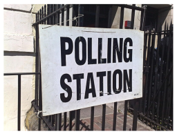 Sign reading Polling Station attached to railings
