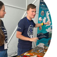 Two people by a toy fish