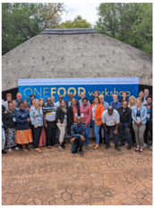 a group of people standing in front of a sign
