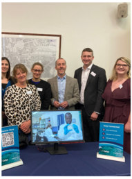 people standing around table with a stand