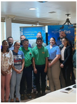a group of people in front of a pull up banner