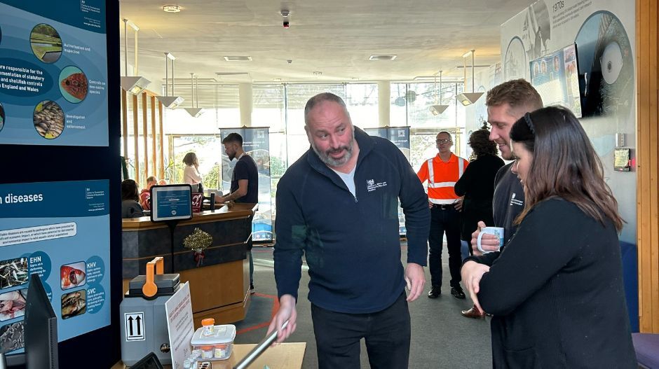 people talking to each other and looking at science kit