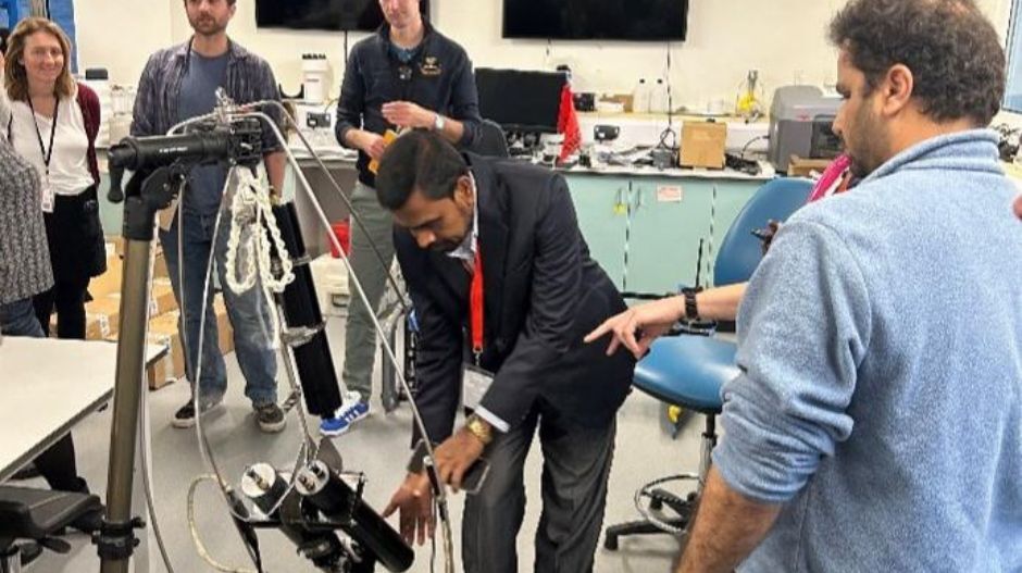 people in a lab looking at equipment