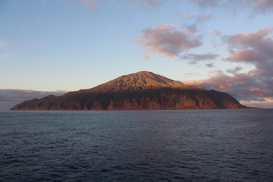 St Helena island in the sunset surrounded by the sea.