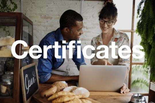 Two people working around a laptop. Text reads 'certificates'