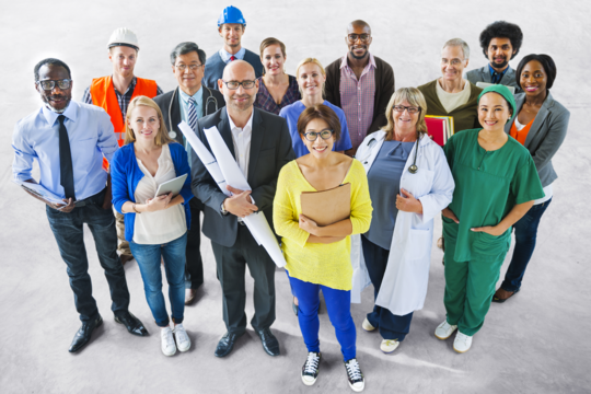 A group of people wearing uniforms from a variety of vocations. 