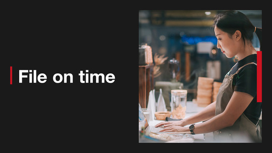 A person working on a laptop in a coffee shop. Text reads: File on time 