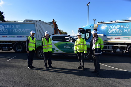 Project partners stood in front of hydrogen refuse collection vehicles