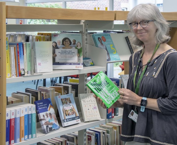 Library staff with book display