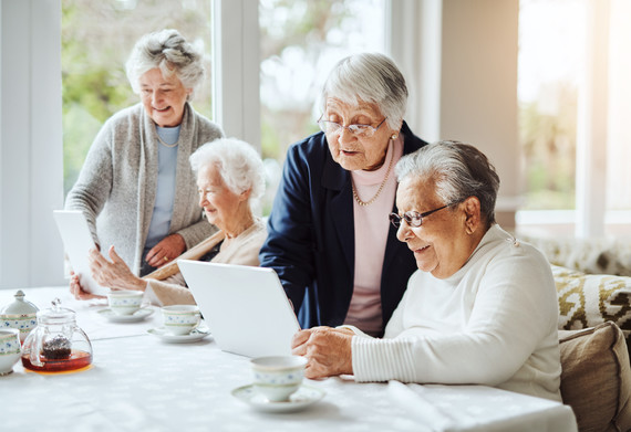 Four people looking at computers together