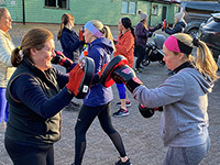 Group of women doing boxercise at Astbury Mere Country Park