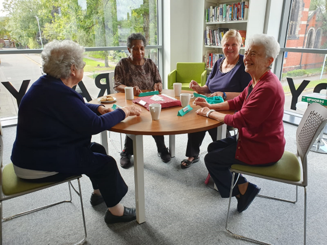smiling ladies meeting at the library