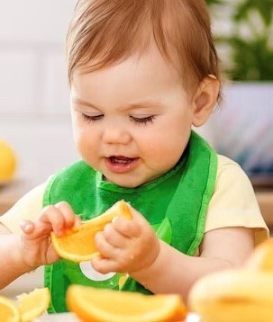 toddler eating fruit 