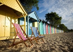 Deckchairs in front of beach huts