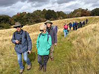 Walkers walking across a countryside field