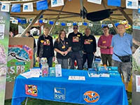 Group of Wildlife Explorer volunteers under an awning