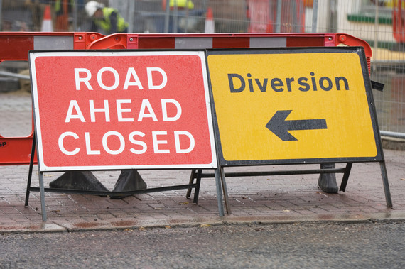 Close up of road closed and diversion signs.