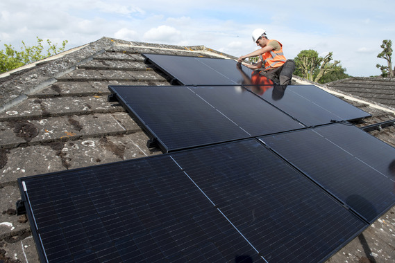 Image of person installing solar panels