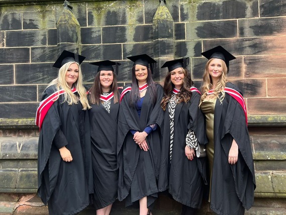 Group of people in graduation gowns and caps